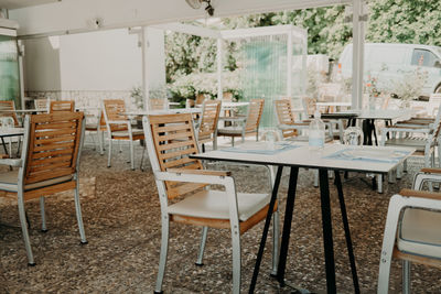 Empty chairs and tables in restaurant