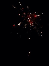 Low angle view of firework display at night