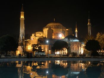 Reflection of illuminated building in water at night