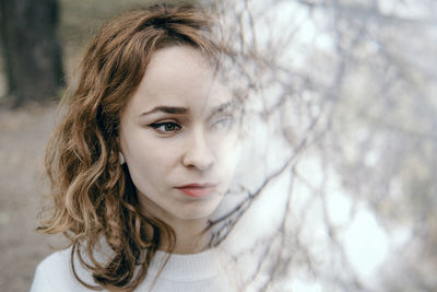 Double exposure image of woman with trees