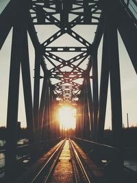 Railway bridge against sky during sunset