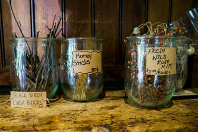 Close-up of herbs in glass container with label at store