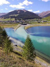 Scenic view of lake by mountains against sky