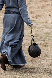 Low section of man holding shoes