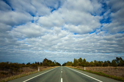 Empty road along countryside landscape