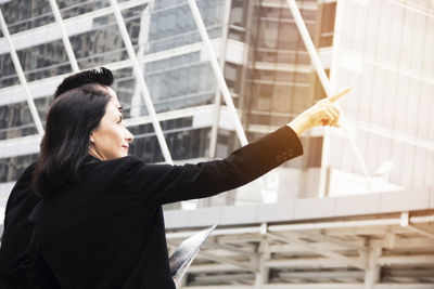 Business people discussing while standing by building