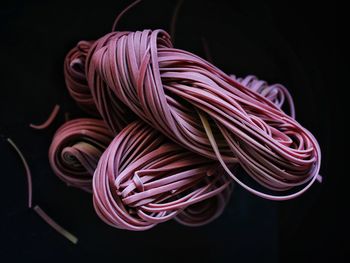 Close-up of rubber bands over black background