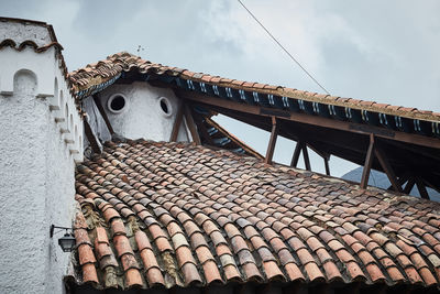 Low angle view of roof and building against sky