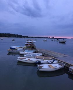Boats moored at pier on sea