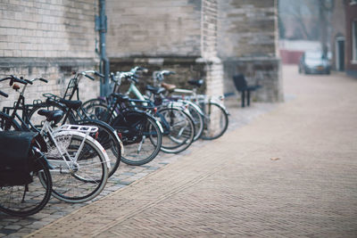 Bicycles parked against brick wall