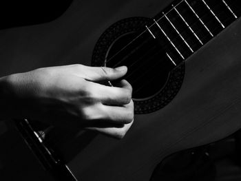 Cropped image of man holding guitar