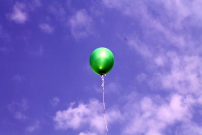 Low angle view of balloons against blue sky