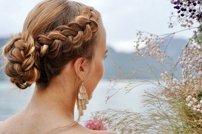 Close-up of woman standing against sky