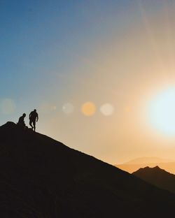 Silhouette of people standing on landscape