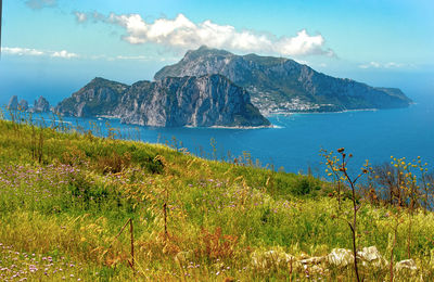 Scenic view of sea and mountains against sky