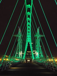 Illuminated bridge at night