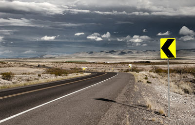 Road sign against sky