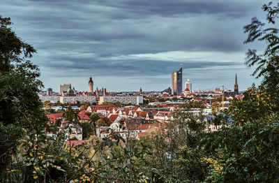 High angle view of buildings against cloudy sky