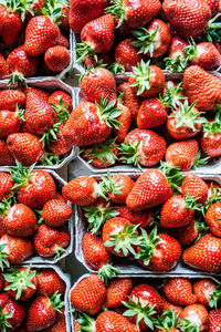 Full frame shot of fresh strawberries in containers for sale at market
