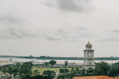 Panoramic view of building and trees against sky