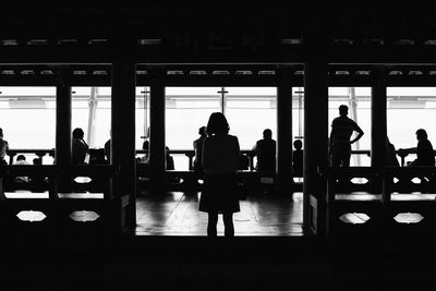 Silhouette man and woman standing in corridor