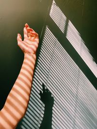High angle view of woman hand on shadow