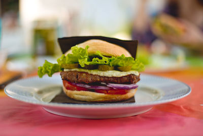 Close-up of hamburger served on table at restaurant