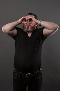 Portrait of man wearing mask against gray background