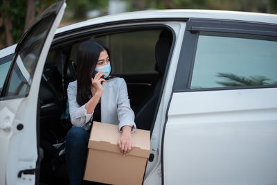 Full length of woman using mobile phone