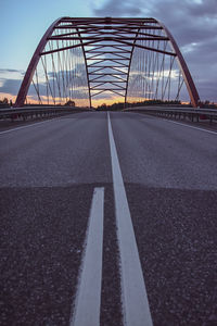 Surface level of road on bridge against sky in city