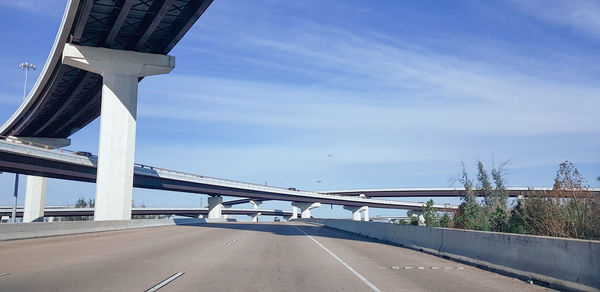 Bridge over highway against sky in city