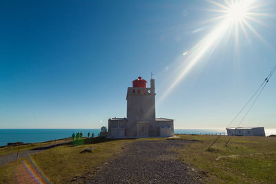 Dyrholaey lighthouse on rock landscape photo