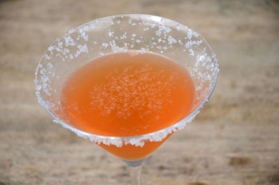 Close-up of orange drink served on table