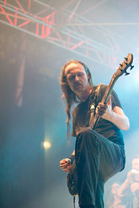 Man playing guitar at music concert