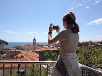Woman photographing city