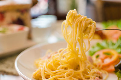 Close-up of yellow served in plate on table