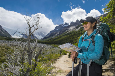 Woman hiking in the andes mountain range towards cerro torre