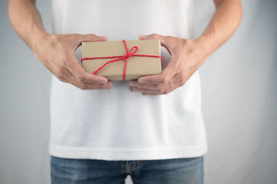 Midsection of woman holding camera in box