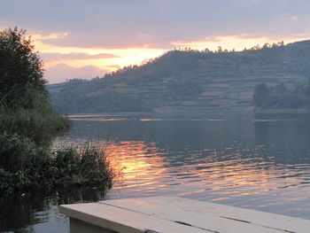 Scenic view of lake against orange sky