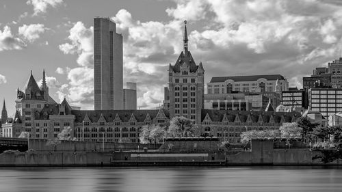 Buildings against cloudy sky