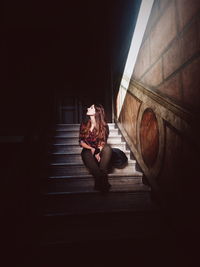 Young woman sitting on stairs