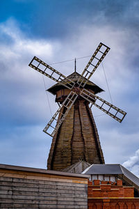 Low angle view of traditional windmill against sky