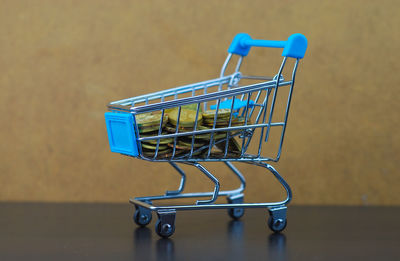 Stacked coins in toy shopping cart