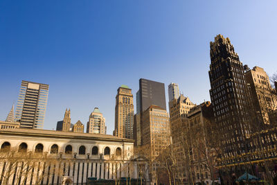 Low angle view of buildings against blue sky