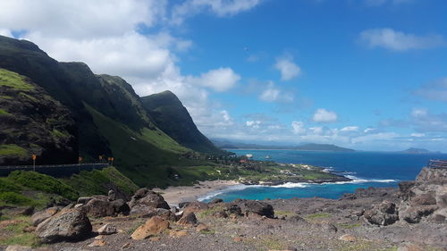 Scenic view of sea and mountains against sky