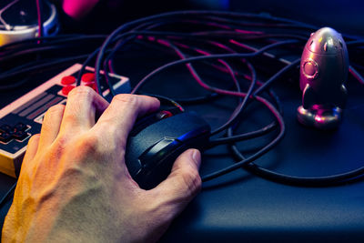 Cropped hand of man using computer mouse