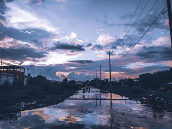 Scenic view of city against sky at sunset