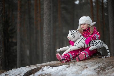 Portrait of smiling girl sitting on snow