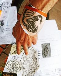 High angle view of man painting on paper