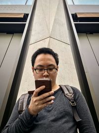 Portrait of young man using mobile phone